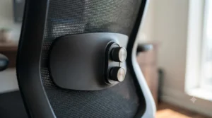 Close-up of the adjustable lumbar support system on an extra high back office chair designed for back pain relief.