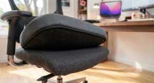Underside view of an office chair cushion featuring anti-slip rubber grip dots.
